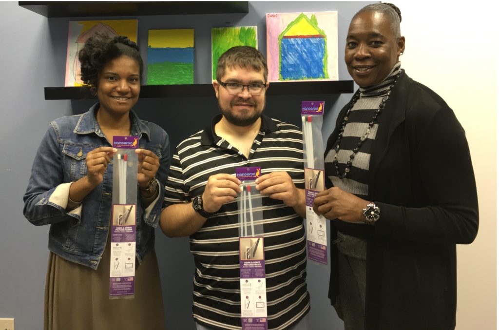 At InReach: Jennifer (Employment Manager), Lewis (InReach customer) and Tonya (Jobs Coach). Lewis assembles the Hangeroo kits.